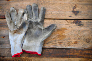 A worn and dirty glove showing signs of wear, highlighting the need for regular maintenance to extend the lifespan of PPE.